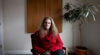 Portrait of Marlean Ames sitting in a chair in a law office.