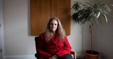 Portrait of Marlean Ames sitting in a chair in a law office.