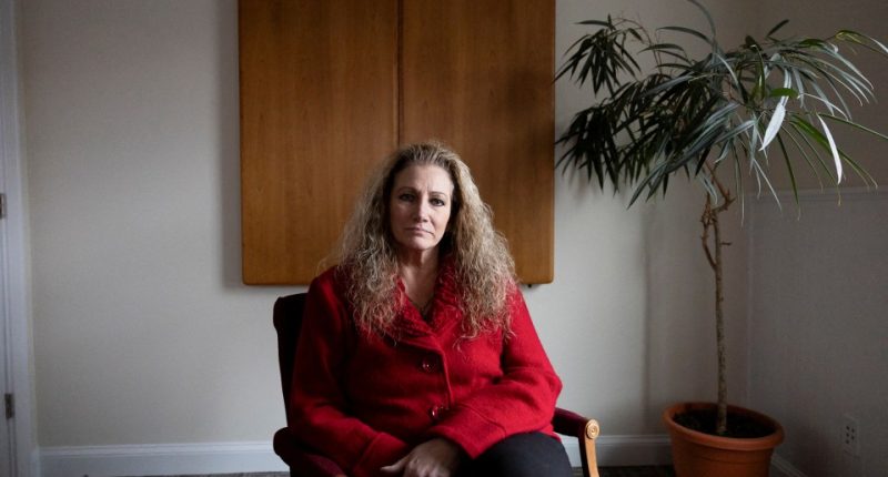 Portrait of Marlean Ames sitting in a chair in a law office.