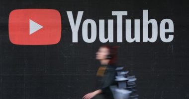 A young woman wearing headphones walks past a billboard advertisement for YouTube on September 27, 2019 in Berlin, Germany. YouTube has evolved as the world's largest platform for sharing video clips. (Photo by Sean Gallup/Getty Images)