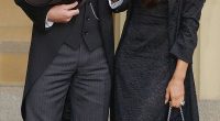 David Beckham stands with his wife Victoria Beckham after receiving his OBE in 2003