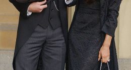 David Beckham stands with his wife Victoria Beckham after receiving his OBE in 2003