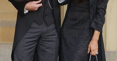 David Beckham stands with his wife Victoria Beckham after receiving his OBE in 2003
