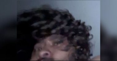 Blurry image of a man with curly hair