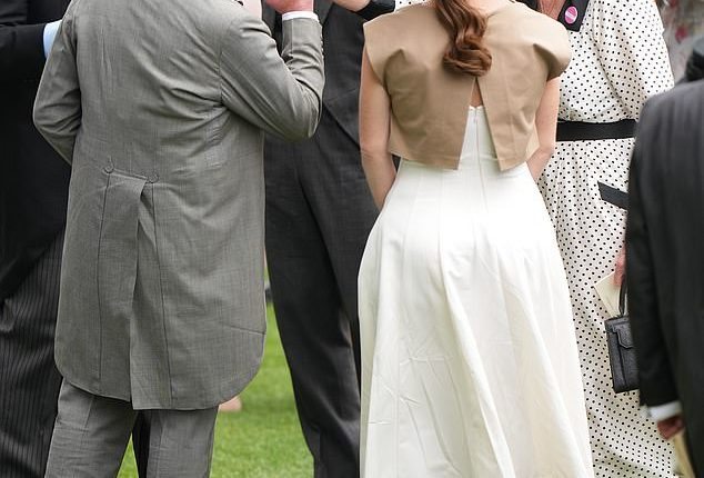 A kiss for Fergie! The King pecks the hand of Sarah Ferguson at the Berkshire racecourse