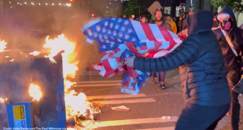 Man saves US flag from flames at anti-ICE protest in Seattle