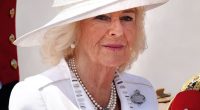 Queen Camilla (pictured) donned a white silk crepe dress with silver embroidery by Anna Valentine with a hat by Philip Treacy as she made her way for today's festivities