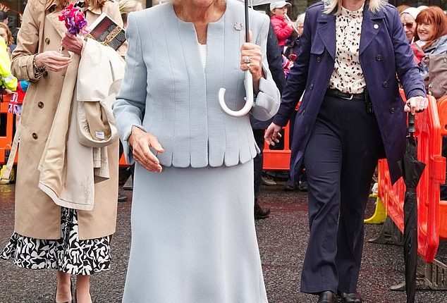 The Queen (pictured) has braved the rainy weather to visit what she called 'the most beautiful racecourse' and open a new stand that has been named in her honour today