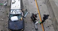 Video: Protesters throw rocks at officers from LA freeway bridge