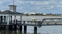 Police boat approaching a pier.