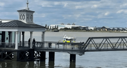 Police boat approaching a pier.