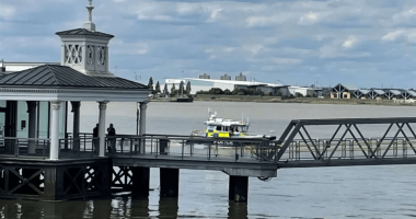Police boat approaching a pier.