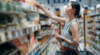 Woman grocery shopping in a supermarket.