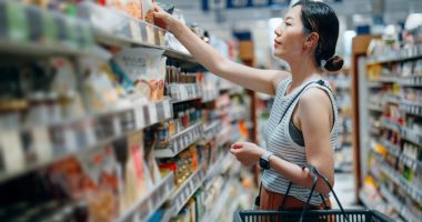Woman grocery shopping in a supermarket.