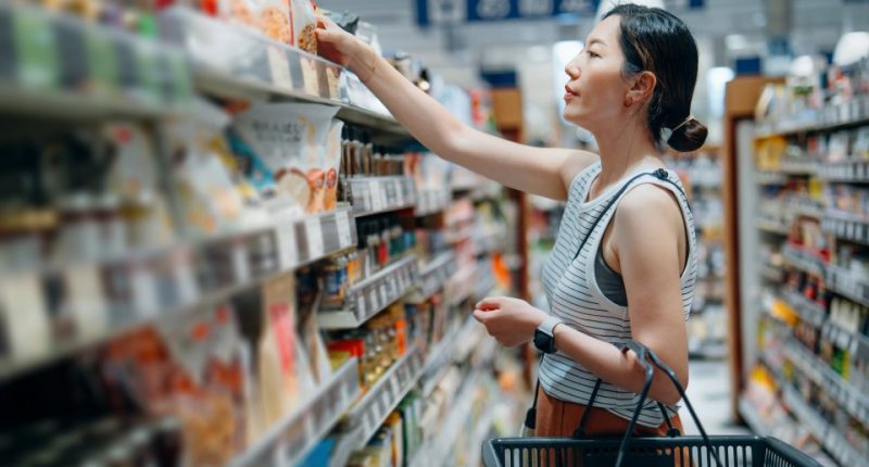 Woman grocery shopping in a supermarket.