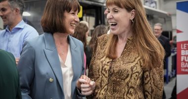 Rachel Reeves and Angela Rayner smiling and holding hands.
