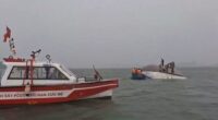 A search party searches Ha Long Bay after a tourist boat capsized.