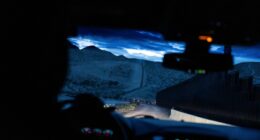 A man is halted climbing the US-Mexico border wall. Under new Trump rules, US troops sound the alarm