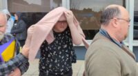 Birdie Kingston covering her face after her case was briefly heard at Penrith Local Court in Sydney, Friday, July 18, 2025.
