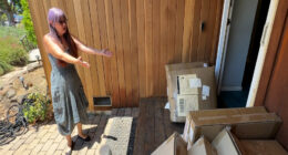 Woman standing in front of her house, surrounded by numerous Amazon packages.