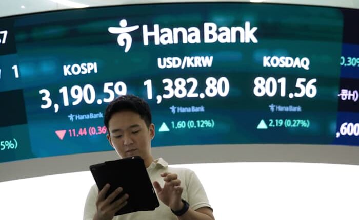 Asian shares are mixed after Nvidia nudges Nasdaq to a record, while other US stocks slump