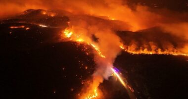 Aerial view of a large wildfire at night.