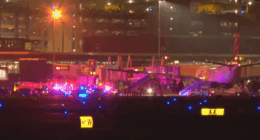 Emergency vehicles surrounding an airplane on an airport tarmac at night.