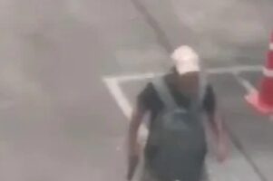Suspect walking in a parking lot near Or Tor Kor Market in Bangkok, Thailand.