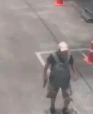 Suspect walking in a parking lot near Or Tor Kor Market in Bangkok, Thailand.