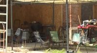 Exterior of a cluttered shed where two children lived.