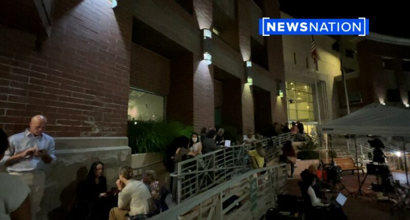 A line of people outside the courthouse.