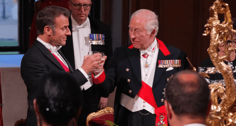 King Charles III and Emmanuel Macron toasting.