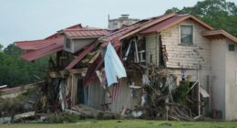 Flood-damaged building with its roof torn off.