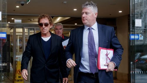 Australian musician Ian Moss (left) leaves the John Maddison Tower Courts with his lawyer Paul McGirr in Sydney, Tuesday, July 8, 2025. (AAP Image/Nikki Short) NO ARCHIVING