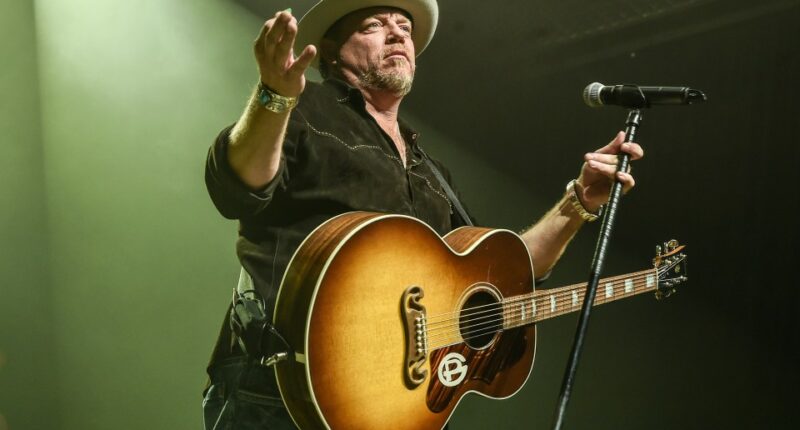 Pat Green performing with an acoustic guitar.