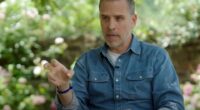 Man in denim shirt speaks outdoors.