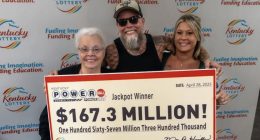 Kentucky Powerball jackpot winners holding a $167.3 million check.