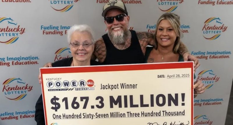 Kentucky Powerball jackpot winners holding a $167.3 million check.