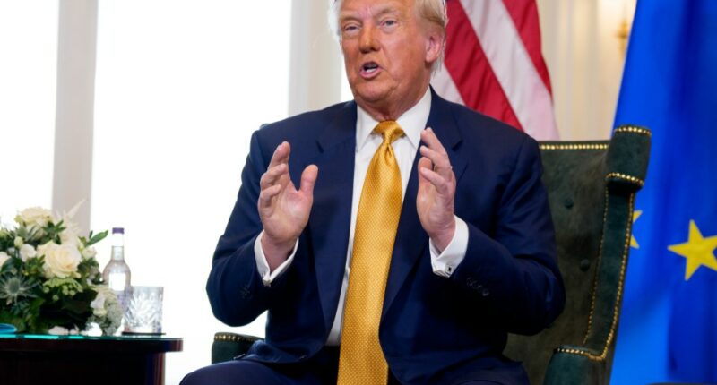Donald Trump speaking at a meeting.