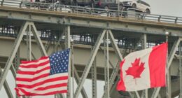 A truck carrying vehicles crosses the Blue Water Bridge into the US from Sarnia, Ontario