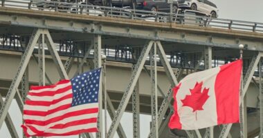 A truck carrying vehicles crosses the Blue Water Bridge into the US from Sarnia, Ontario
