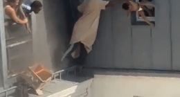 Man catching baby dropped from window.