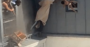 Man catching baby dropped from window.