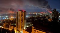 Kyiv at night with smoke rising after a missile strike