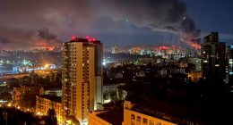 Kyiv at night with smoke rising after a missile strike
