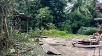 Debris from a rocket strike damaging a house.