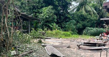 Debris from a rocket strike damaging a house.