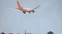 Airplane landing over houses.