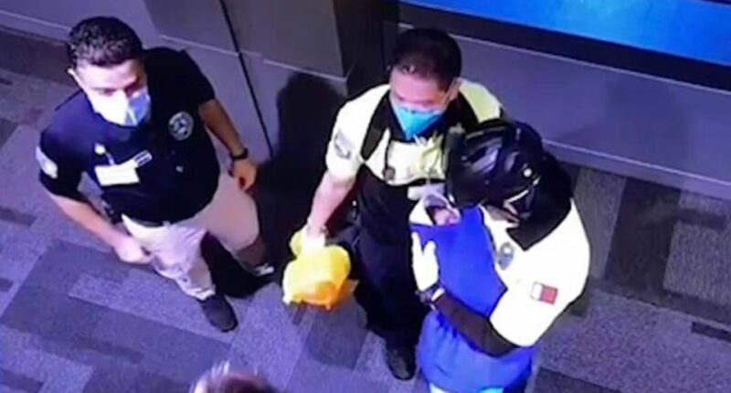 CCTV footage of authorities in Qatar holding a baby found in a toilet bin at Hamad Airport.
