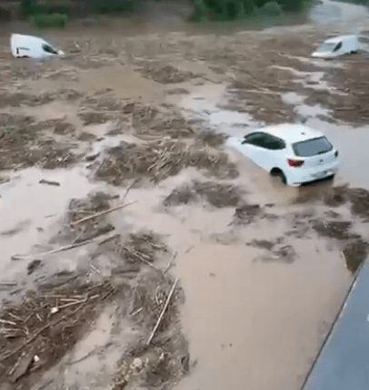 Cars submerged in floodwaters.